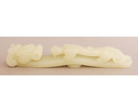A CHINESE CELADON JADE BELT HOOK, of traditional form, 4.9in long.
