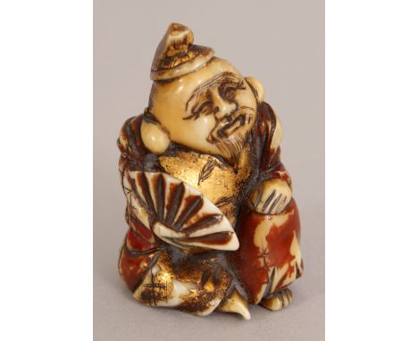 A SIGNED JAPANESE LACQUERED & GILDED IVORY NETSUKE OF EBISU, kneeling and holding a fan, the base with an engraved signature,