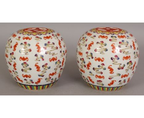 A PAIR OF CHINESE FAMILLE ROSE PORCELAIN HAT STANDS, each top surface pierced with 'cash', the sides decorated with bats and 