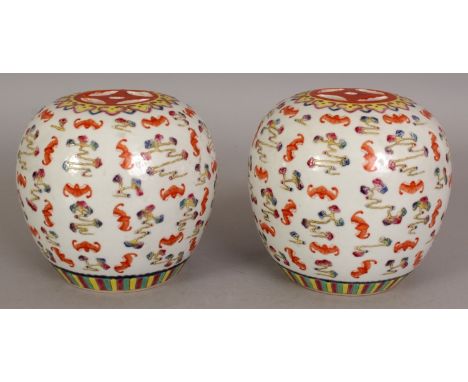 A PAIR OF CHINESE FAMILLE ROSE PORCELAIN HAT STANDS, each top surface pierced with 'cash', the sides decorated with bats and 