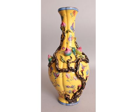 A CHINESE YELLOW GROUND FAMILLE ROSE MOULDED PORCELAIN VASE, of quatrefoil section and decorated in high relief with branches