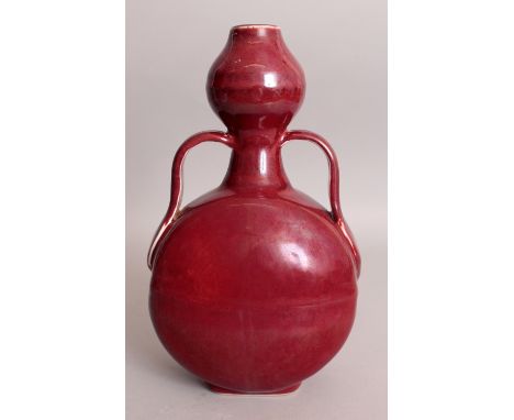 A CHINESE MING STYLE RED GLAZED PORCELAIN MOON FLASK, the base with an archaic mark in underglaze-blue, 6.6in wide at widest 