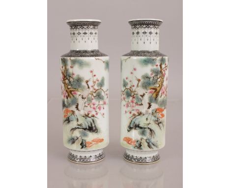 A MIRROR PAIR OF CHINESE REPUBLIC STYLE PORCELAIN ROULEAU VASES, each decorated with a pair of cranes on rockwork beside pine