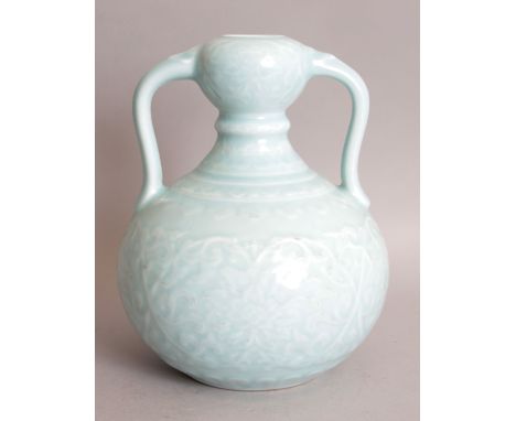 A CHINESE CELADON PORCELAIN VASE, with loop handles, the sides moulded beneath the glaze with formal scrolling lotus, the bas