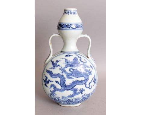 A CHINESE MING STYLE BLUE & WHITE PORCELAIN DRAGON MOON FLASK, the neck with an extended six-character Xuande mark, 5.9in wid