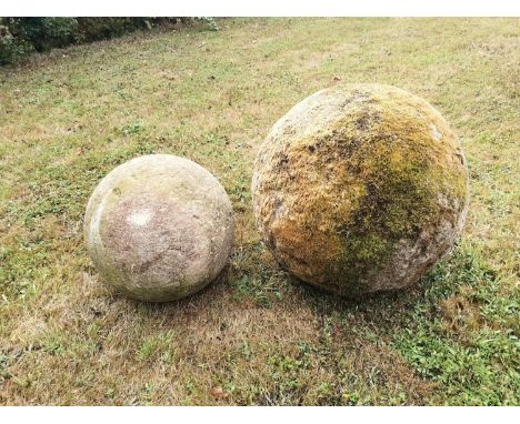 Gate piers: A substantial carved Cotswold stone ball, 52cm diameter, together with a smaller carved Cotswold stone ball, 37cm