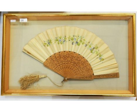 Painted silk and stamped wood fan, framed, pierced and stamped, with a silk tassel, depicting violets and weaving tools, poss
