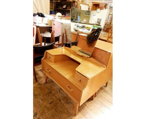 20th century G-Plan light oak dressing table with shaped mirror above two short and one long drawer, on tapering supports, 92