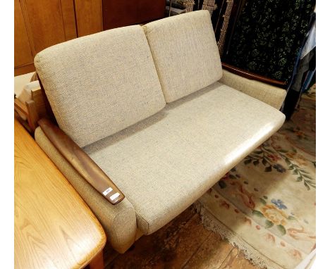 Mid 20th century sofabed finished in a light blue upholstery, hardwood arm rests and raised upon turned supports