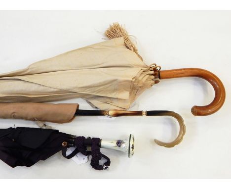 Vintage umbrella with a guilloche enamel handle, in cream with decoration of violets, another umbrella and a cream cotton par