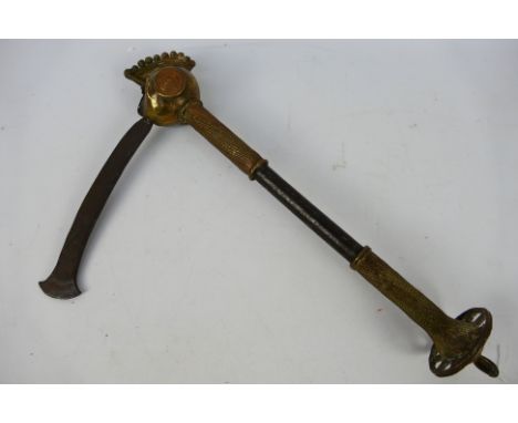 An African ceremonial parade axe, Benue (Tiv people), the head of the haft in the form of a human head with the blade emergin