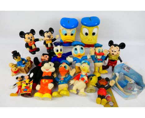 Walt Disney - A collection of vintage Disney related items to include figures, money banks, soft toys, flexible models and ot