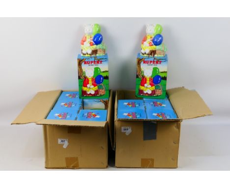 Twelve ceramic Rupert The Bear money banks, all unused, contained in original boxes and housed in trade boxes. [2]. [W]