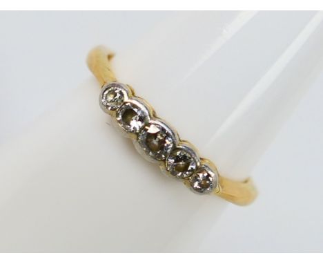 An unmarked yellow metal (presumed 18ct) diamond set ring, size K, approximately 2 grams. [W]