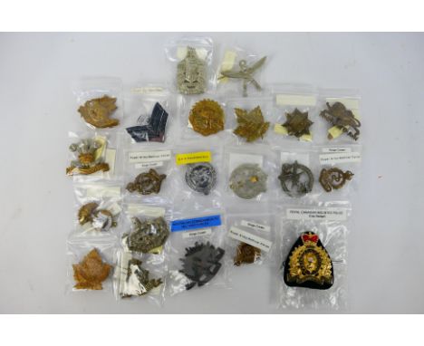 A collection of cap badges and similar insignia to include Royal Army Medical Corps, 13th (Kensington) Battalion, Army Air Co