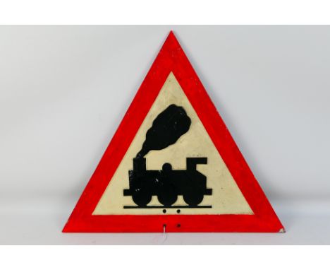 A vintage cast alloy road sign, Level Crossing Ahead With No Barrier, triangular, red, white and black, cast verso I.R.S Ltd 