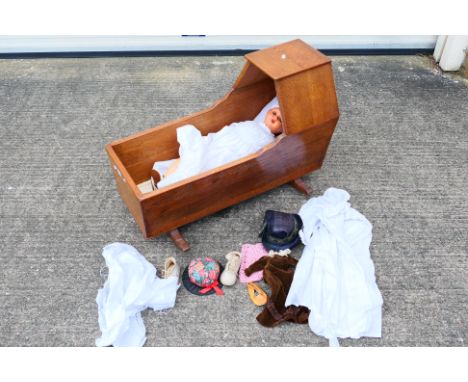 An unmarked doll with jointed head, arms, knees and legs with sleeping eyes, open mouth showing upper teeth, impressed to the