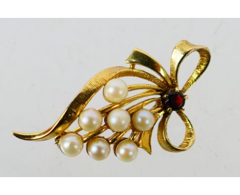 A 9ct yellow gold brooch set with pearl beads and garnet, approximately 6.8 grams. [W]