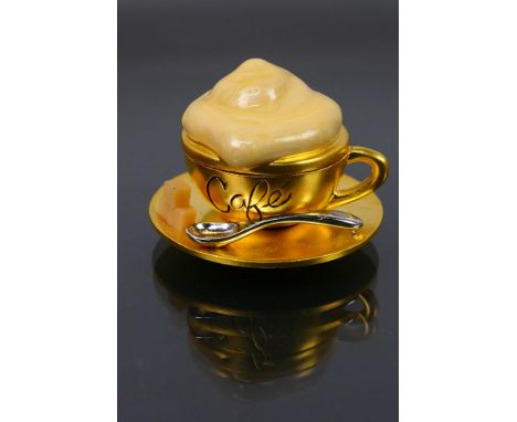 Estee Lauder - A boxed gilt metal Estee Lauder Beautiful Cafe Cup solid perfume compact. Compact has single hinge, cream enam