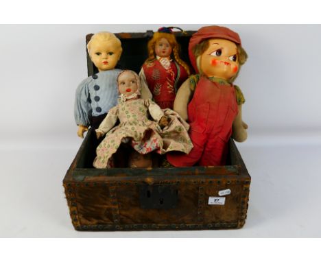 Four unmarked dolls in a vintage trunk. Dolls include a Portugese type wood filled doll (has hole in foot) a bisque headed 'w