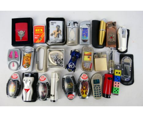 A collection of cigarette lighters, predominantly novelty examples with one boxed Zippo El Diablo. [W]