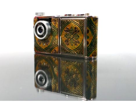 A Walter Kunik Petie vintage Vanity case Camera. The camera which is beautifully patterned has colours of chrome, gold, brown