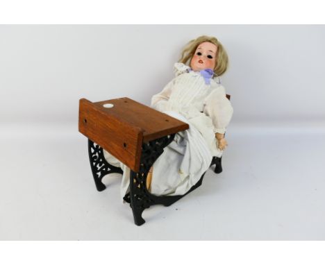 Schoenau & Hoffmeister - A bisque headed fully jointed doll by Schoenau & Hoffmeister. The doll measures approximately 43cms 