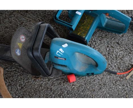 Makita electric hedge cutter together with a Black &amp; Decker electric chainsaw