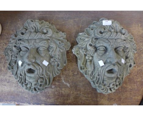 A pair of Bacchus concrete garden wall plaques 
