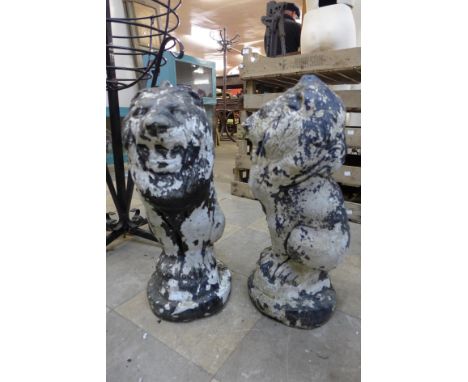 A pair of concrete lion garden ornaments 