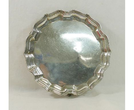 A small silver card tray, with Chippendale rim and three scroll feet, Birmingham 1926, 21cm diameter, 13.94ozt, 433.7g CONDIT