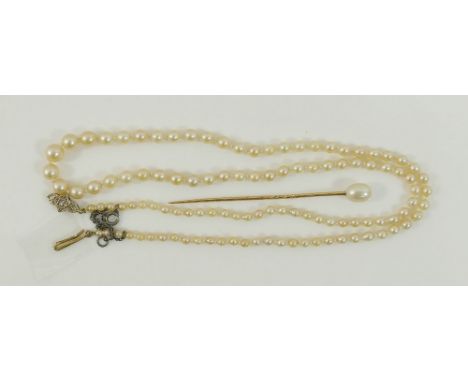 An early 20th century individually knotted graduated cultured pearl necklace, with diamond set yellow metal clasp stamped '9C