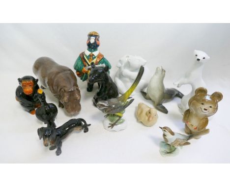 Thirteen bone china and porcelain animal figures comprised of a KPM polar bear group, a Nymphenberg bird and a hippopotamus, 