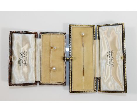 A cultured pearl dress stud, stamped '18CT', and one other smaller similar with indistinct mark, combined weight 2.1g, and a 