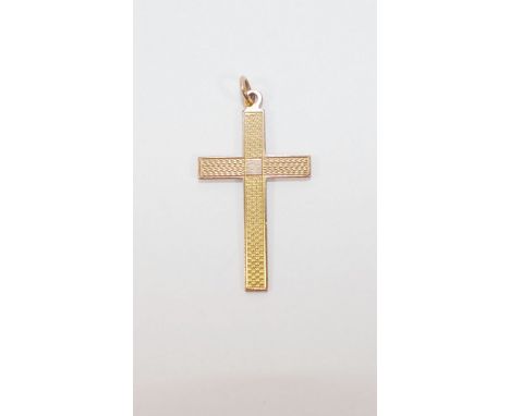 A yellow metal cross pendant, with engine turned decoration, stamped ‘9CT’, 4.7cm long, 1.8g   CONDITION REPORTS & PAYMENT DE
