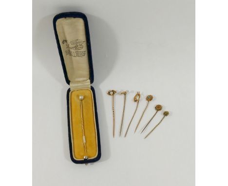A collection of six Victorian and early 20th century gold stick pins, including pearl and diamond set examples, combined weig