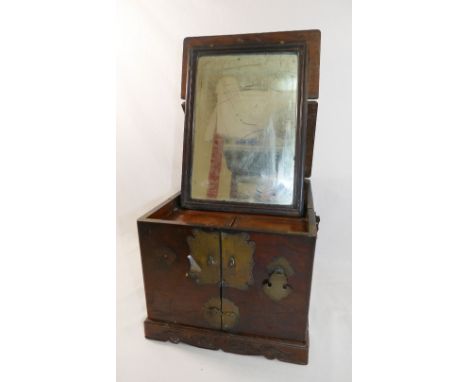 A Chinese brass bound hardwood travelling vanity case, the hinged top fitted with mirror plate, the front opening to reveal 5