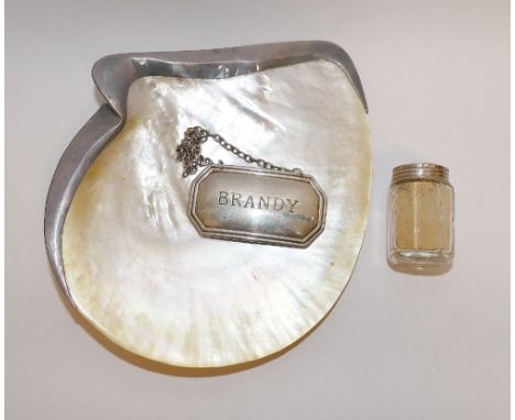 A mother of pearl and silver mounted butter dish, Birmingham 2001, a silver 'Brandy' decanter label and a small Sterling moun