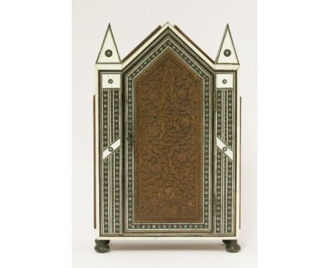 A Vizagapatam sadeli and ivory inlaid table cabinet,late 19th century, with a raised top flanked with arrow head finials, wit