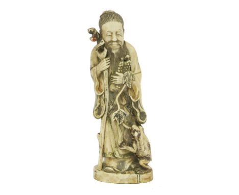 A Chinese ivory sage,late 19th century, with remnants of polychrome decoration,22cm high