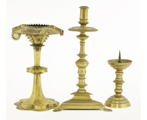 A monstrance,probably 15th/16th century, damaged,22.5cm high,a pricket stick,17th century15.5cm high, anda pricket candlestic