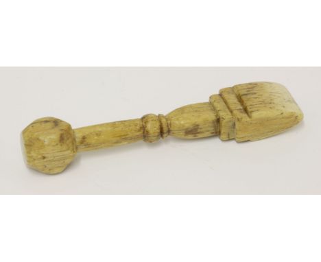 A whalebone seam rubber,19th century, with a dice finial,12cm long
