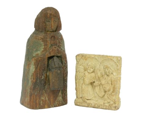 A wooden figure of a bishop,Northern European, holding a lantern and painted,27cm high, anda carved stone panel,depicting the
