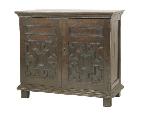 An oak geometric front cabinet,late 17th/early 18th century, with a pine shelf, on block feet,97cm wide42cm deep86cm high