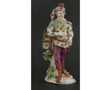 A Derby figure of David Garrick,wearing an elaborate tunic and green cloak, standing on a naturalistic base, baton lacking,22