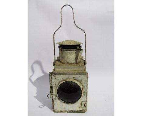 A white painted railway tail lamp
