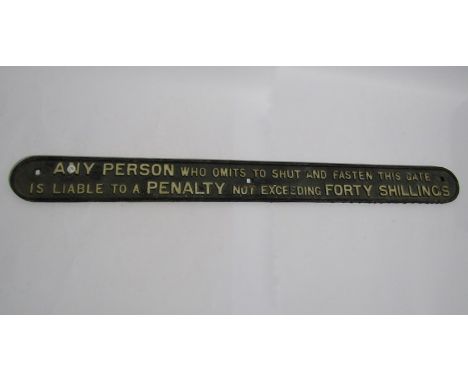 A cast iron PENALTY FOR SHUTTING GATE sign