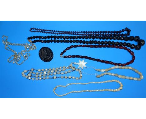 A selection of necklaces:  mother-of-pearl bead; amber type; jet; etc.