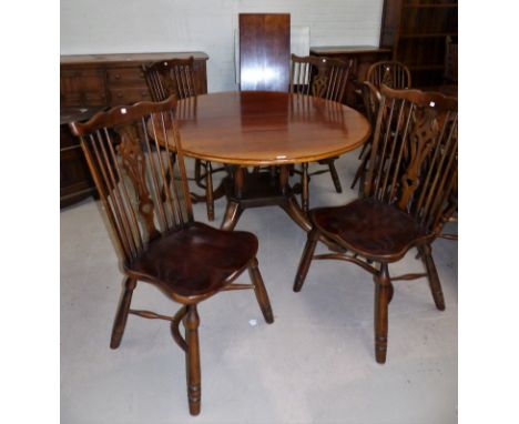 An 18th century style distressed oak dining suite in the manner of Titchmarsh & Goodwin comprising oval extending table on 4 