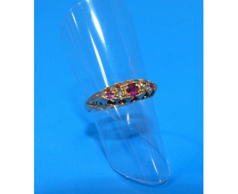 A Victorian style split shank dress ring stamped '18ct' and set with diamond chips and ruby coloured stones - 2.1gm
